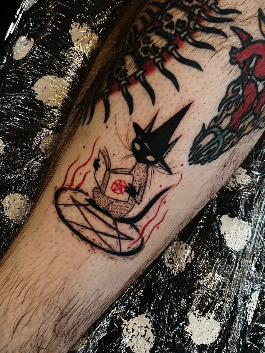 Charming witch cat casting a spell tattoo Tattoo on skin