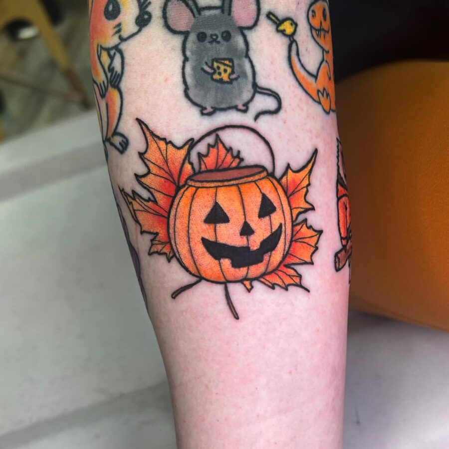 Playful pumpkin tattoo with autumn leaves vibes Tattoo on skin