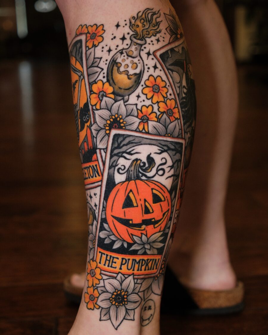 Unique pumpkin tattoo surrounded by flowers Tattoo on skin