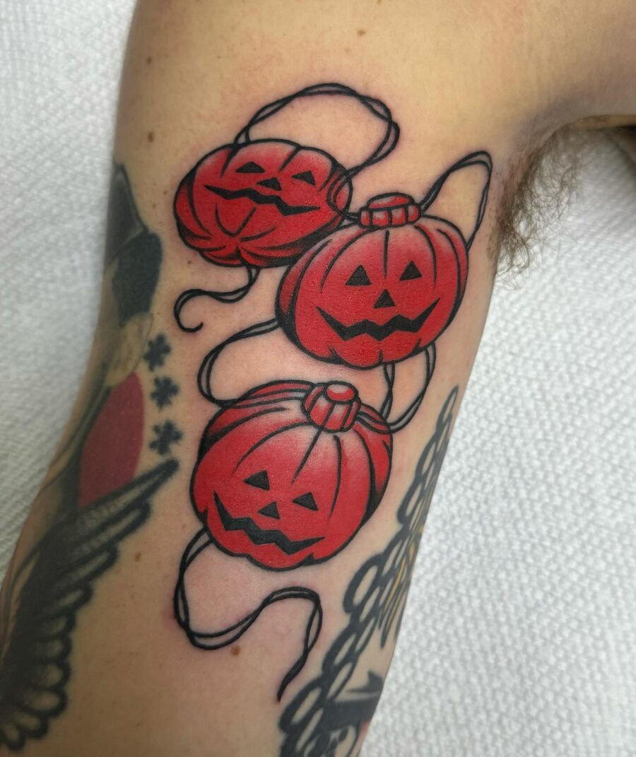 Vibrant Halloween Pumpkins with Playful Expressions Tattoo on skin