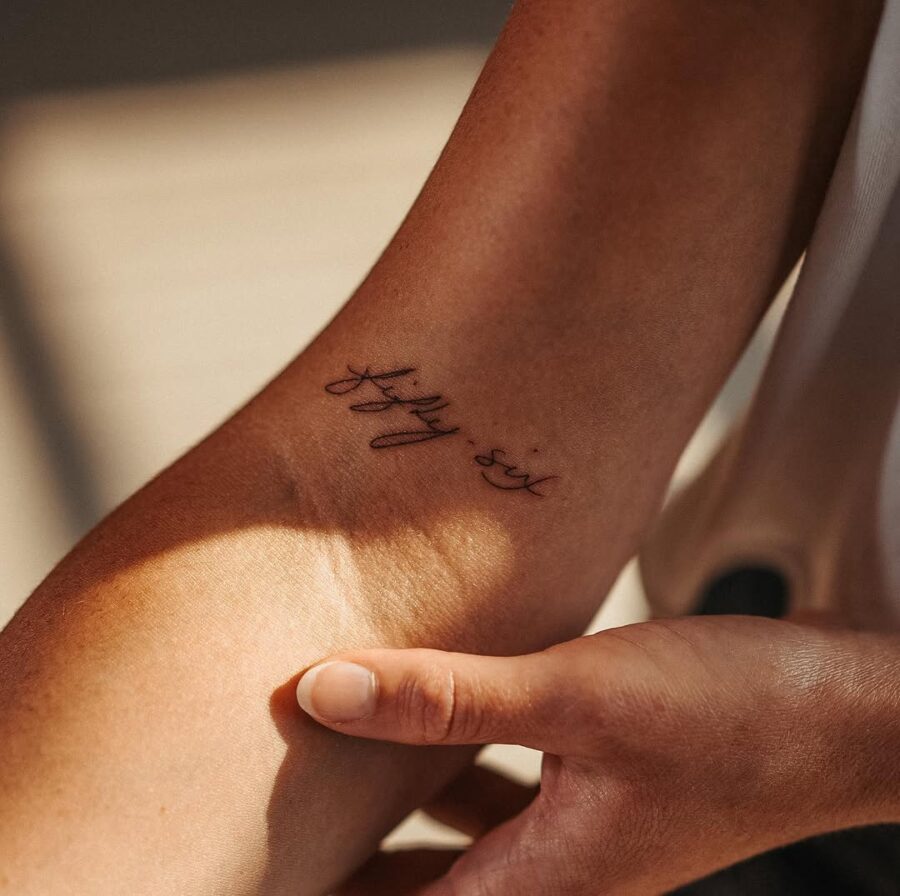 Elegant handwriting tattoo on the arm Tattoo on skin