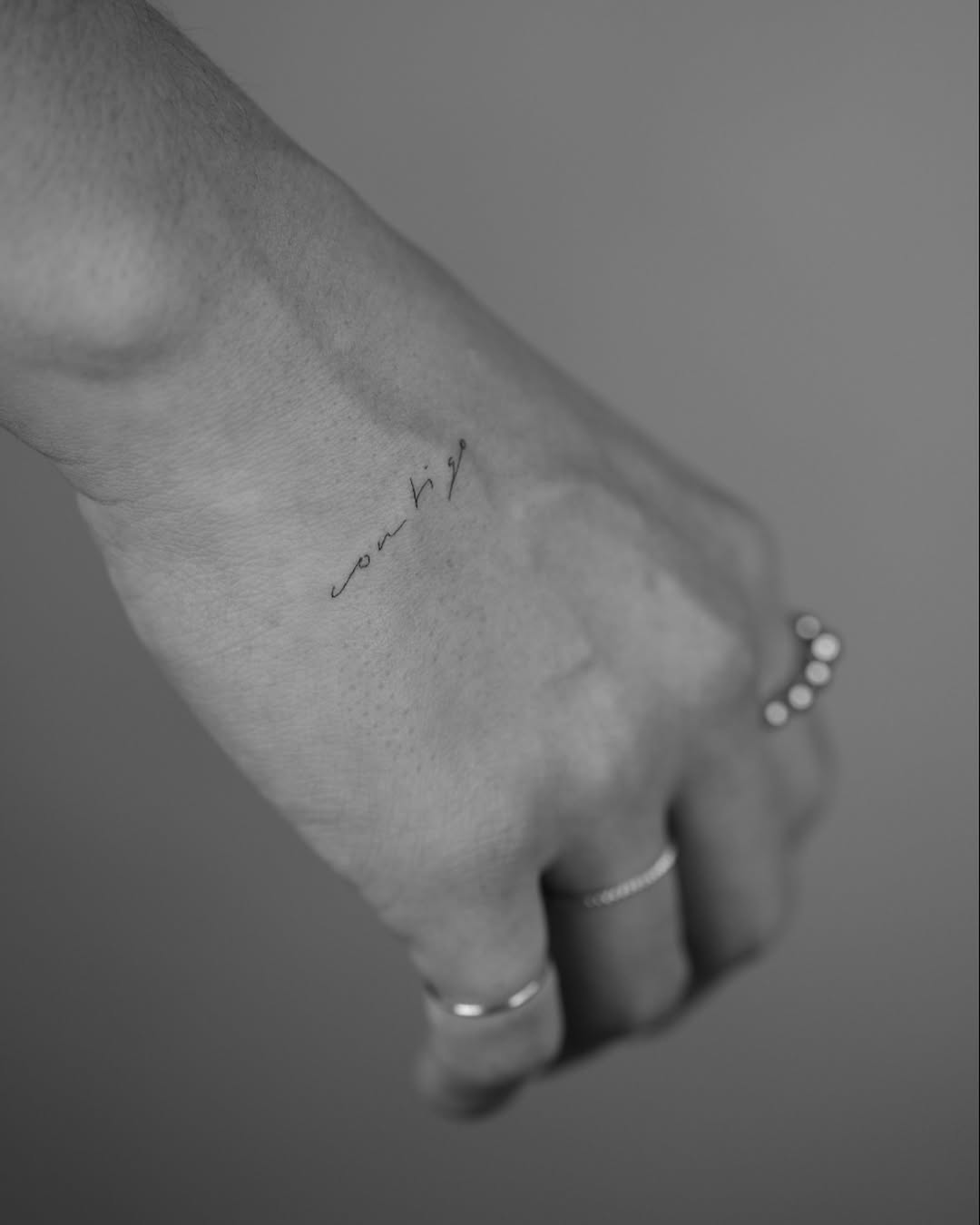 Elegant handwriting tattoo on wrist area Tattoo on skin