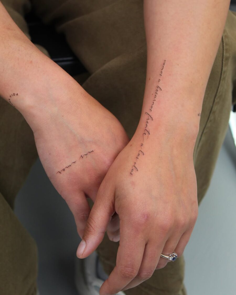 Elegant handwriting tattoos on well-defined arms. Tattoo on skin