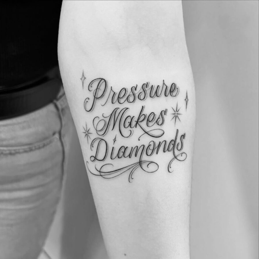 Elegant script tattoo with inspiring message Tattoo on skin