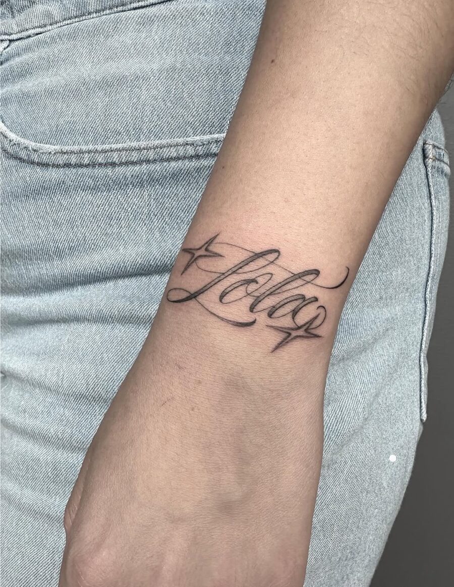 Elegant scripted handwriting tattoo on wrist Tattoo on skin