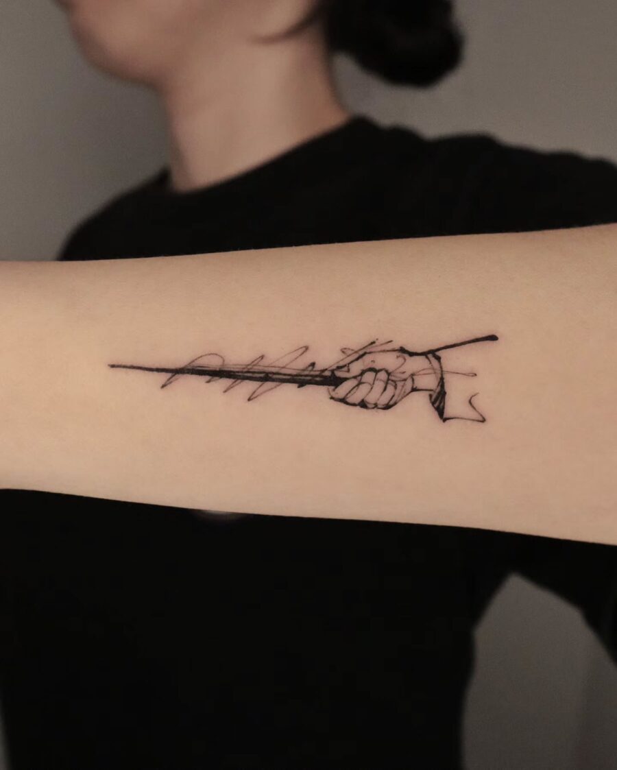 Minimalist Wand Tattoo Symbolizing Magic and Strength Tattoo on skin