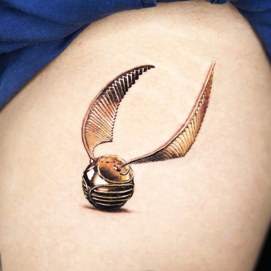 Stunning realistic Golden Snitch tattoo design Tattoo on skin