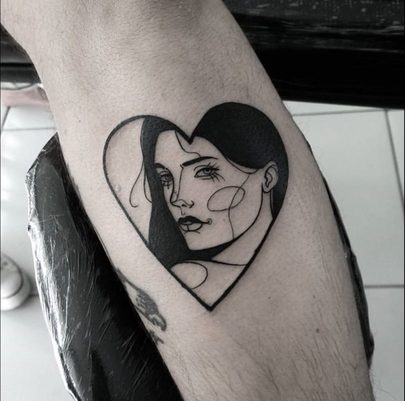 Intensely Bold Heart Tattoo with Harlequin Woman Tattoo on skin