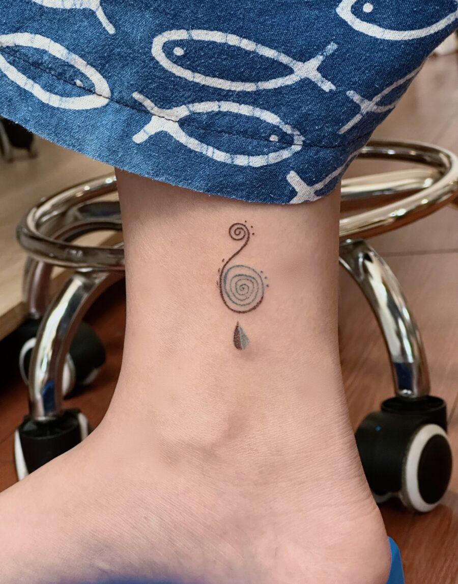 A captivating spiral tattoo on the ankle. Tattoo on skin