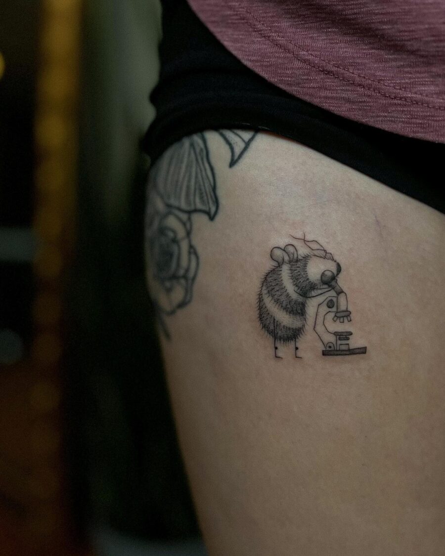 A quirky tattoo featuring a bee scientist Tattoo on skin