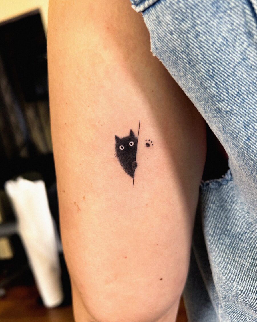 Cute hidden tattoo of a peeking kitten Tattoo on skin