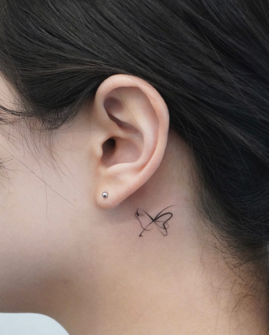 Delicate butterfly tattoo just behind the ear Tattoo on skin