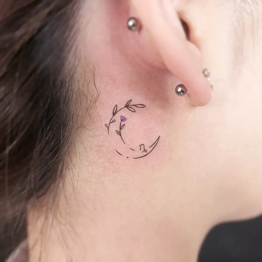 Delicate floral tattoo behind the ear Tattoo on skin