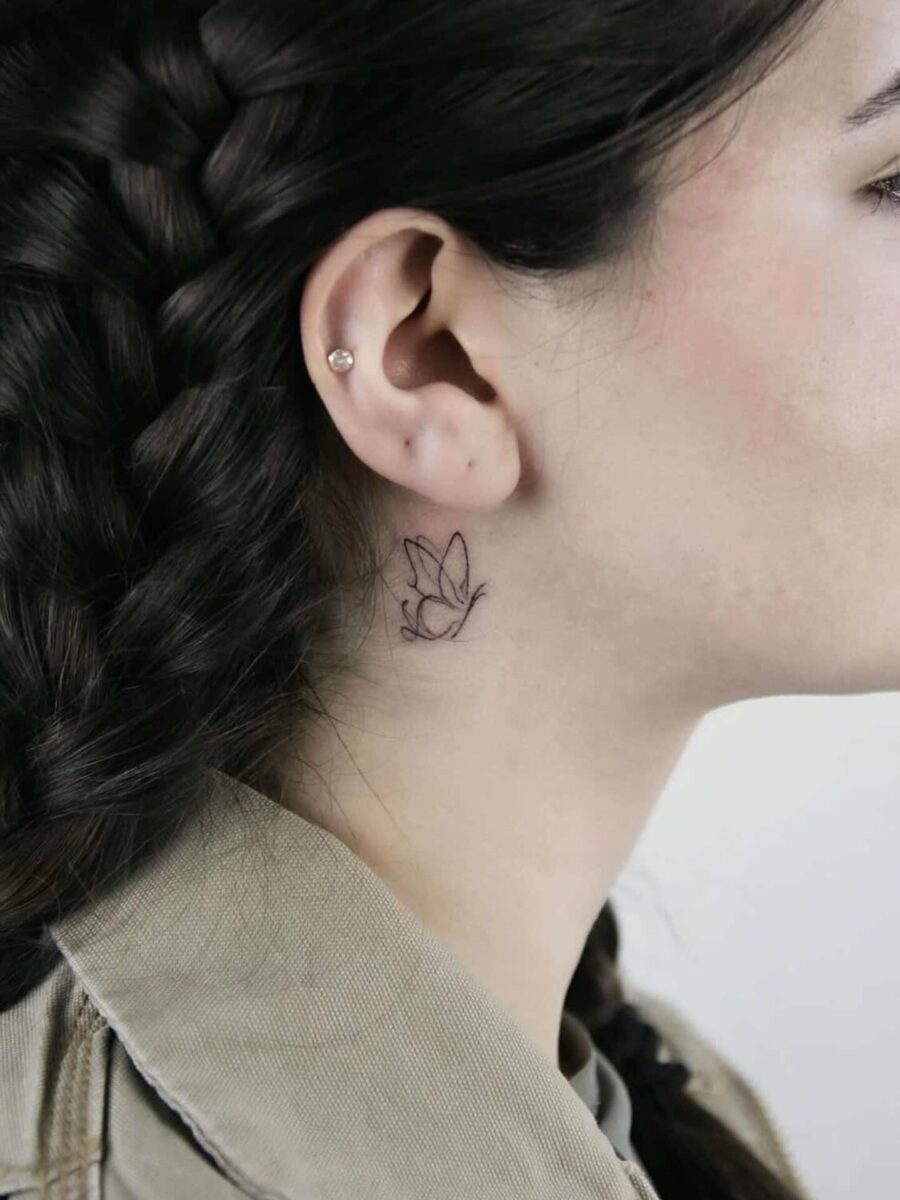 Delicate floral tattoo near the ear Tattoo on skin