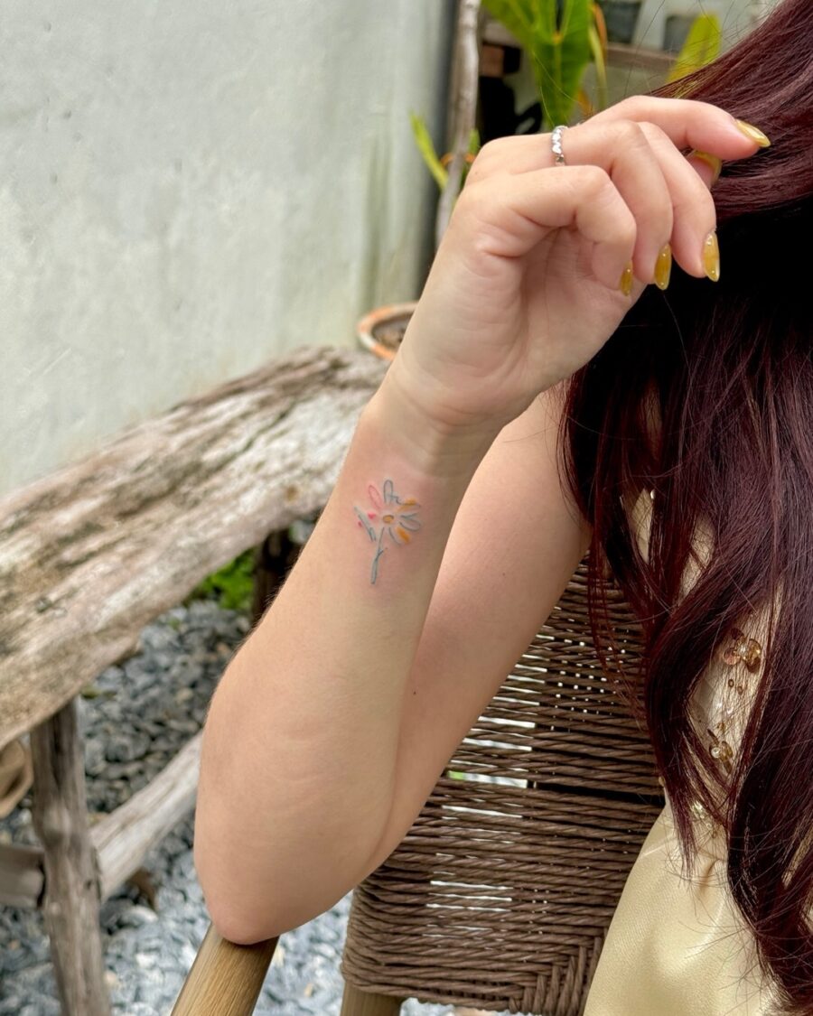 Delicate floral tattoo subtly hidden on arm Tattoo on skin