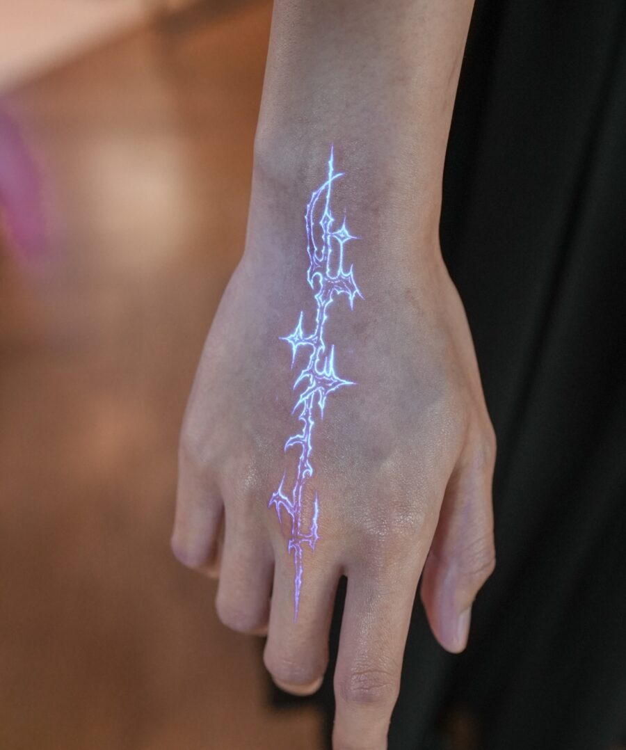 Electric blue hidden tattoo on hand Tattoo on skin