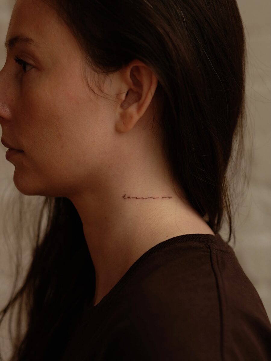 Elegant script tattoo on the neck Tattoo on skin