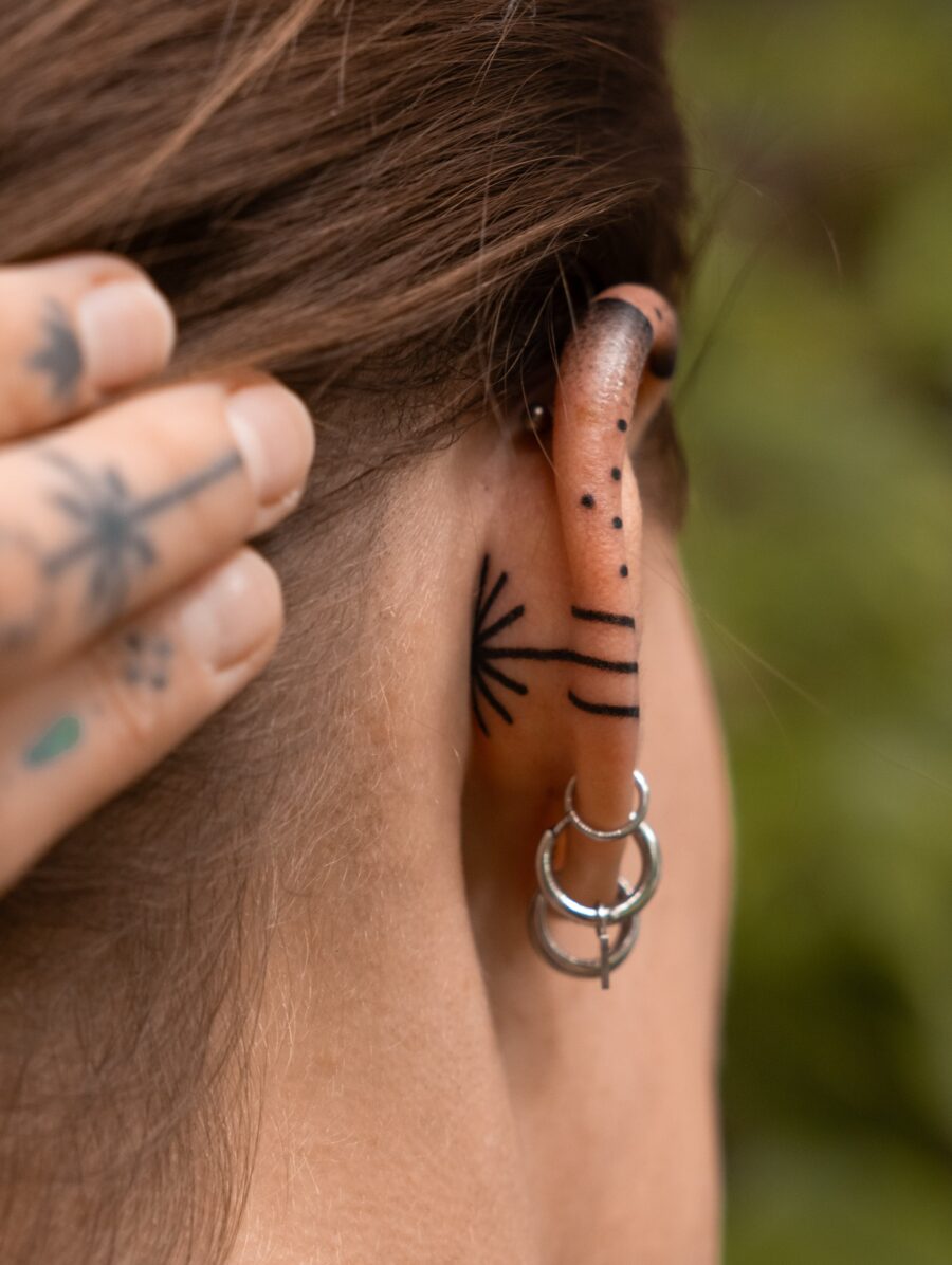Elegant subtlety in ear tattoo designs Tattoo on skin