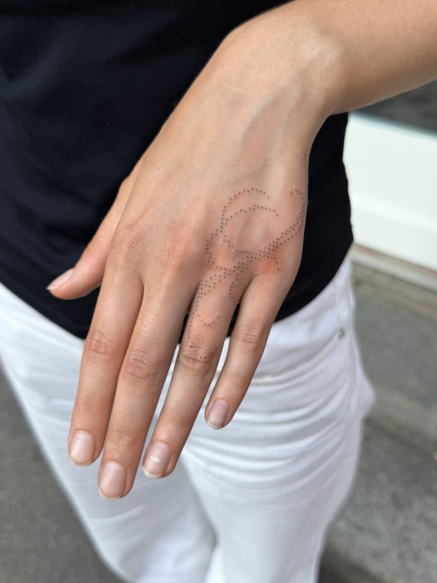 Intricate hand tattoo blending elegance and mystery Tattoo on skin