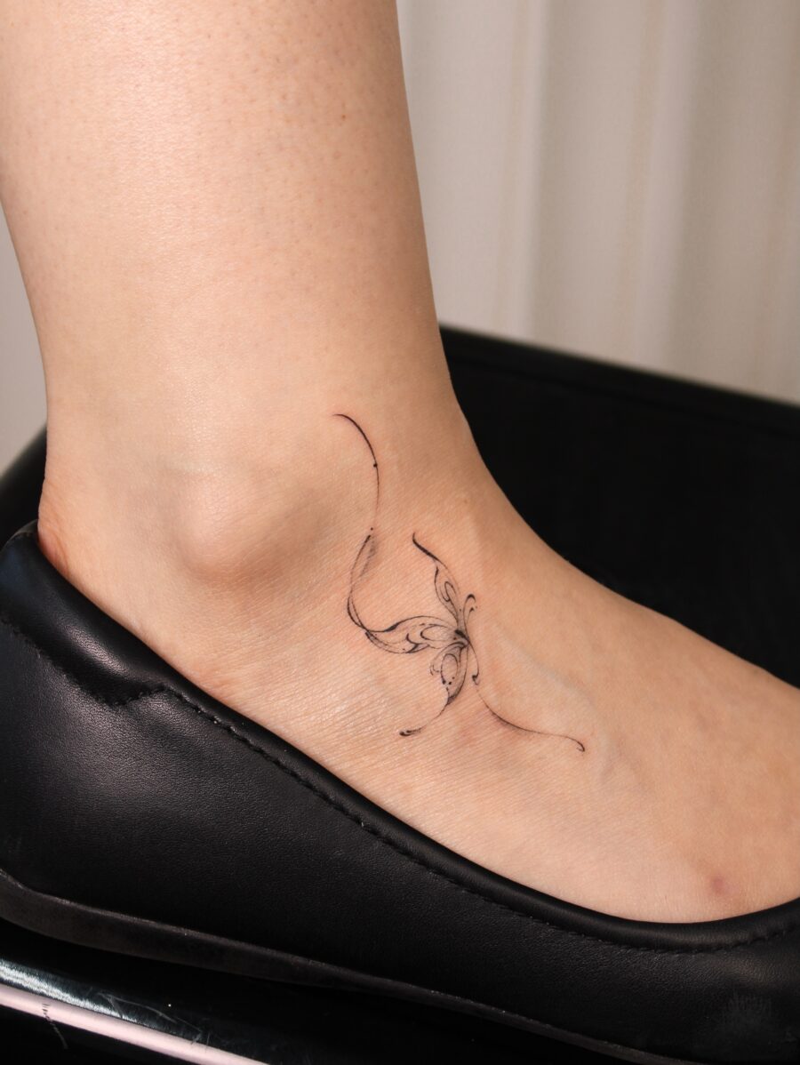 Subtle butterfly tattoo on the ankle area Tattoo on skin