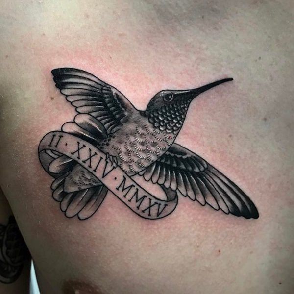 Cartoon-Style Hummingbird Clutching a Scroll Tattoo on skin