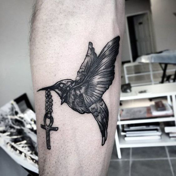 Chrome Hummingbird Holding an Ankh Tattoo on skin
