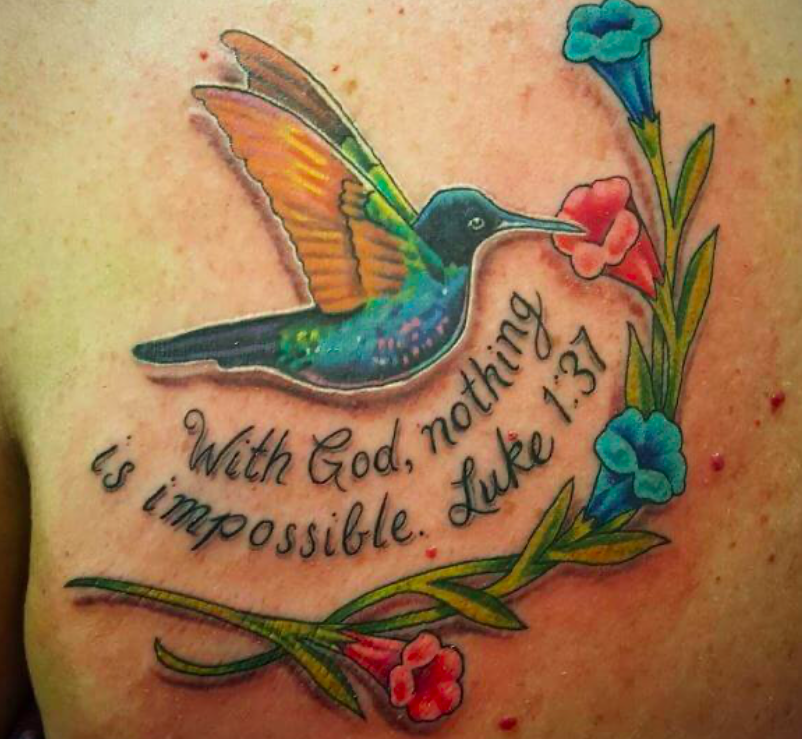 Colorful Hummingbird Framed by Bible Verse Tattoo on skin