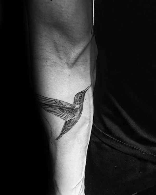 Intricately Detailed Fluttering Hummingbird Tattoo on Arm Tattoo on skin