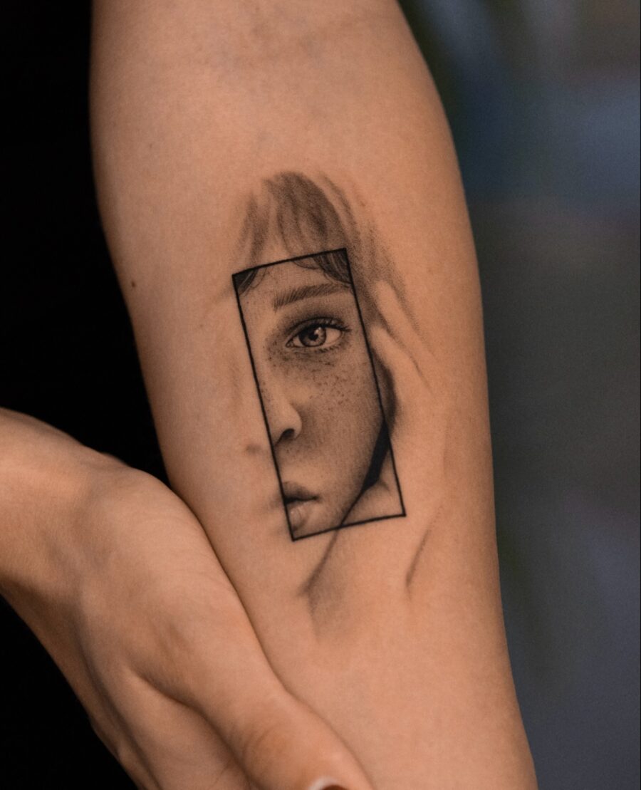 Intricate Tattoo of a Framed Face Tattoo on skin