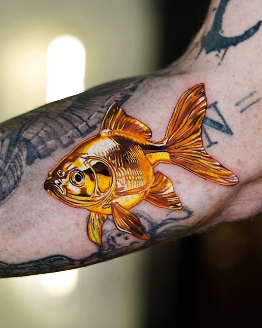 Stunning goldfish tattoo with vibrant detailing Tattoo on skin