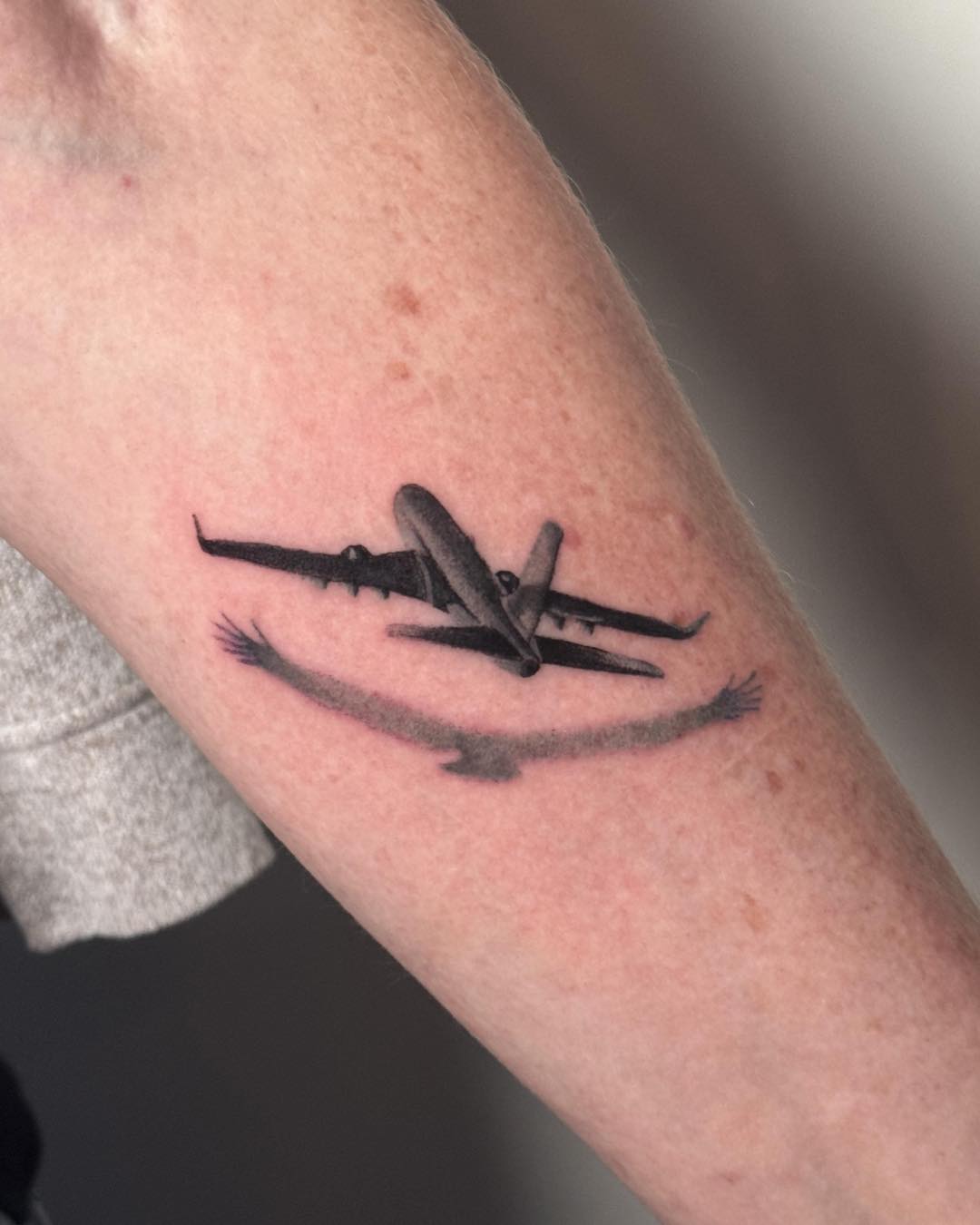 A poignant tribute with an airplane design. Tattoo on skin