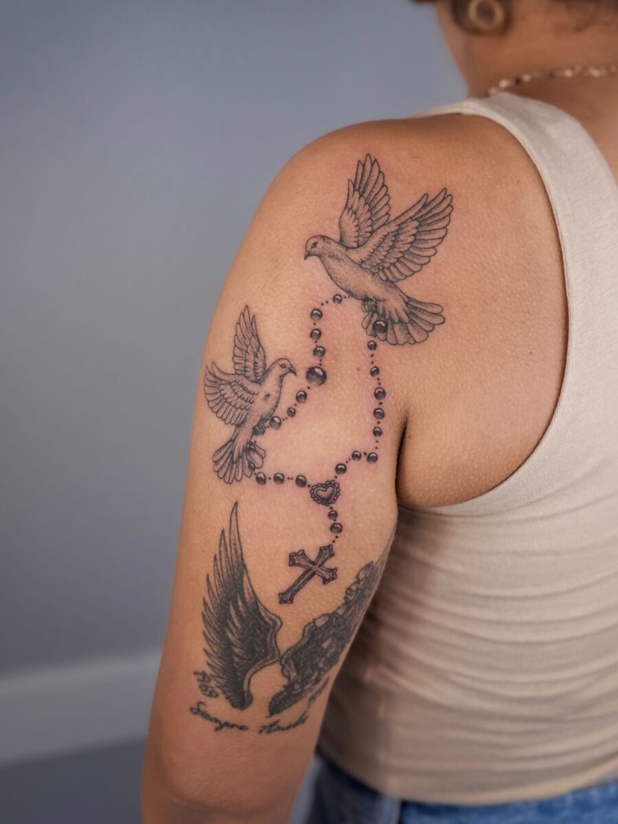 Beautiful tribute tattoo featuring birds and cross Tattoo on skin