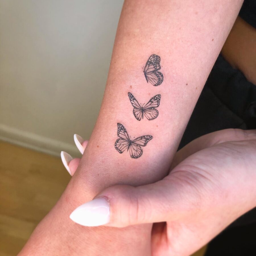 Elegant butterflies representing cherished memories. Tattoo on skin