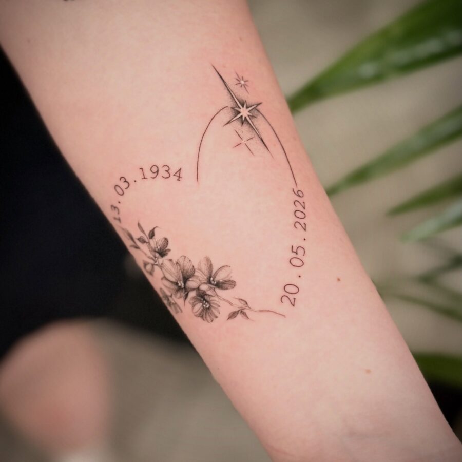 Elegant memorial tattoo with flowers and dates Tattoo on skin