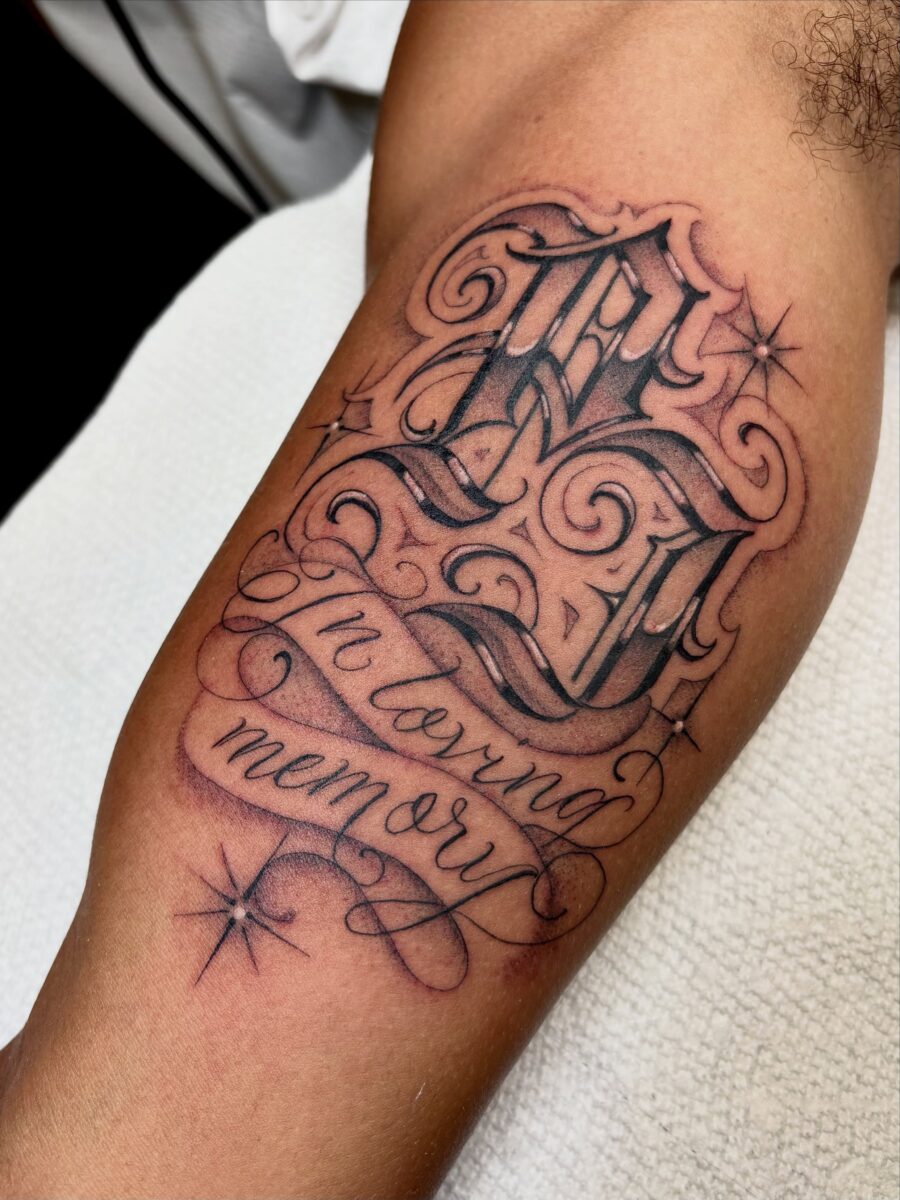 Elegant script tattoo honoring cherished memories Tattoo on skin