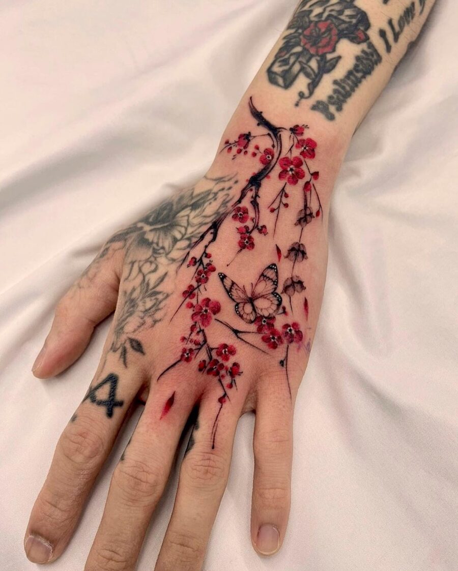Elegant floral hand tattoo featuring a butterfly Tattoo on skin