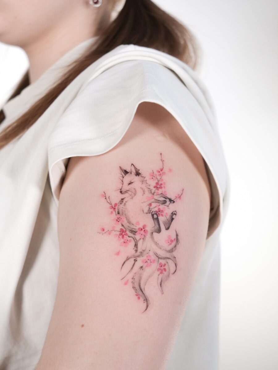 Elegant fox tattoo with cherry blossoms Tattoo on skin