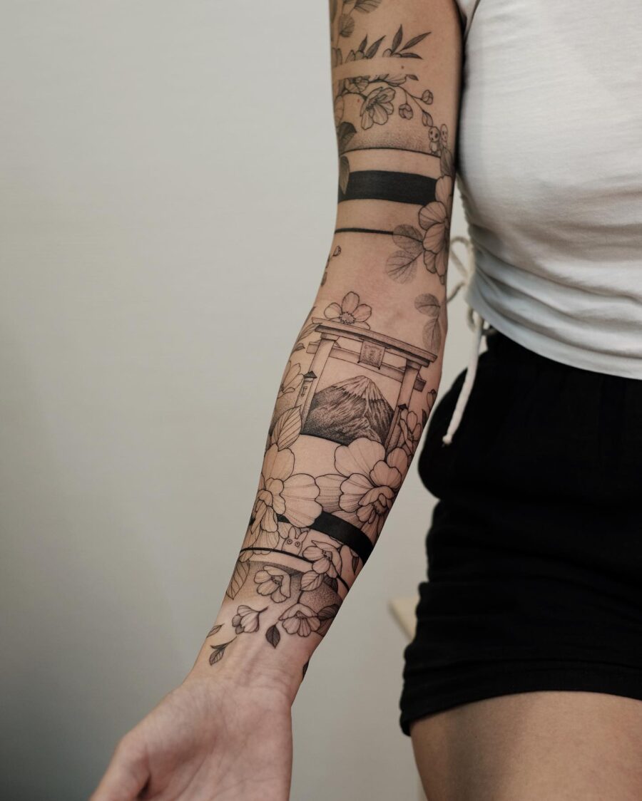 Intricate Japanese-style floral arm tattoo Tattoo on skin
