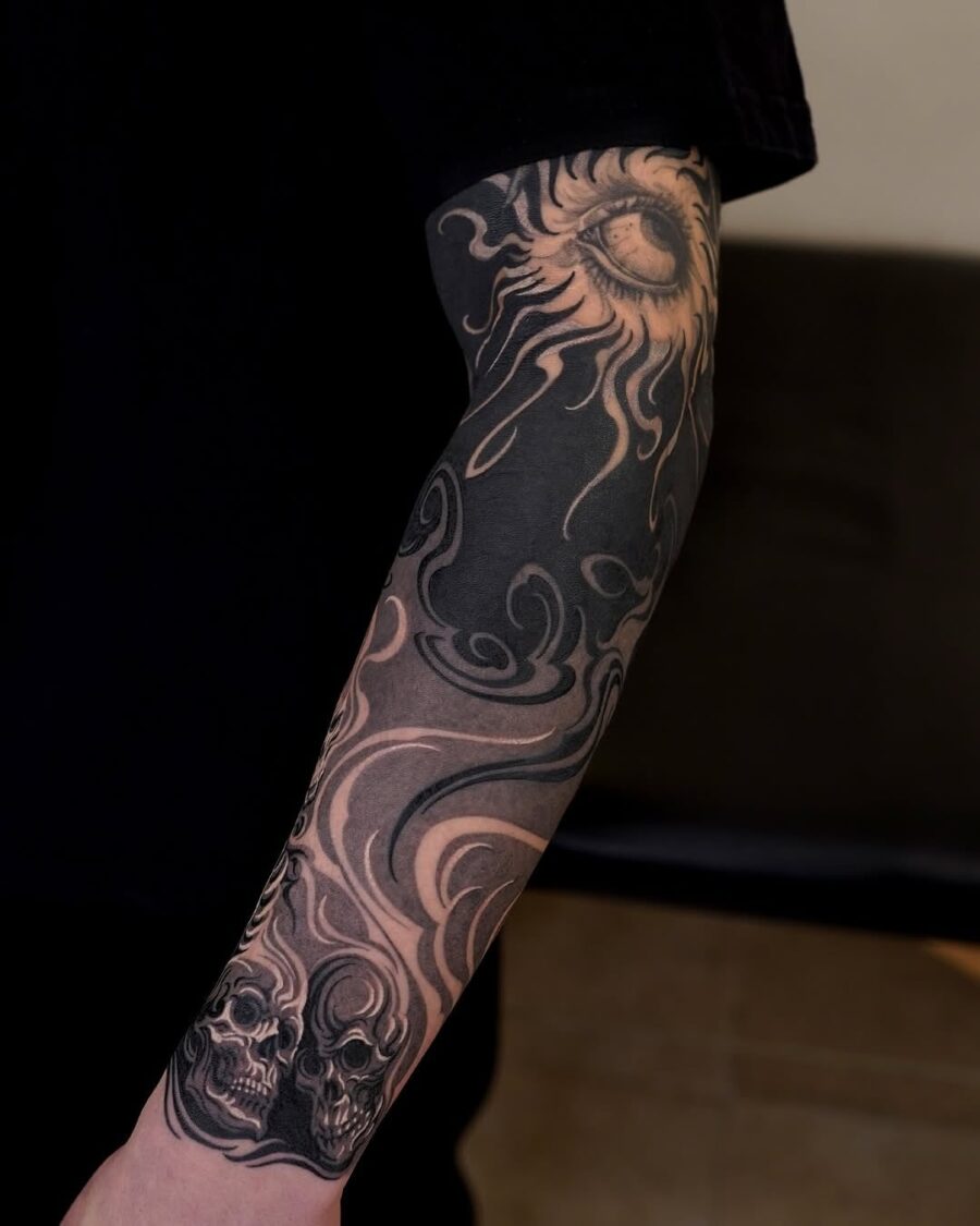 Intricate Japanese tattoo featuring sun and skulls Tattoo on skin