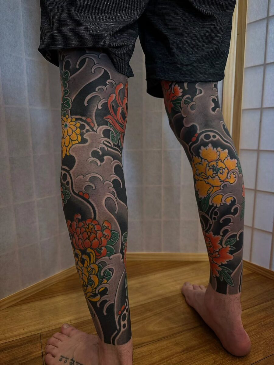 Vibrant floral Japanese tattoos adorn the legs Tattoo on skin