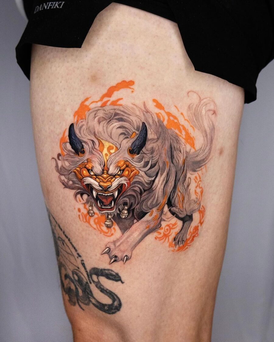 Vibrant Japanese tattoo of a fierce creature Tattoo on skin