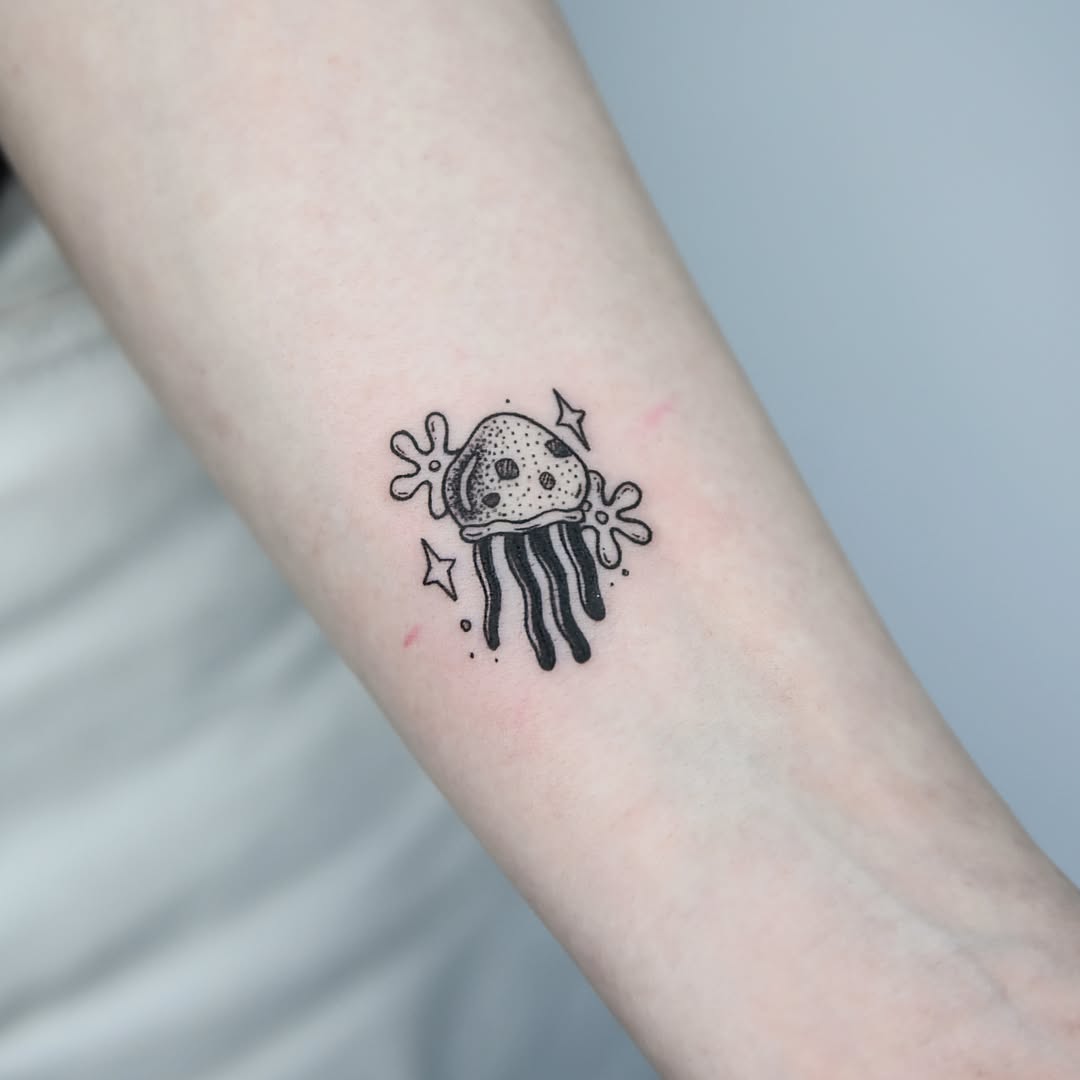 Charming black ink jellyfish with whimsical flair Tattoo on skin