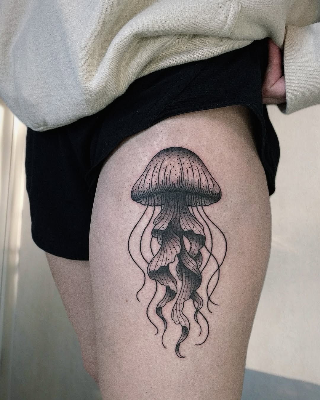 Charming jellyfish tattoo on a thigh Tattoo on skin