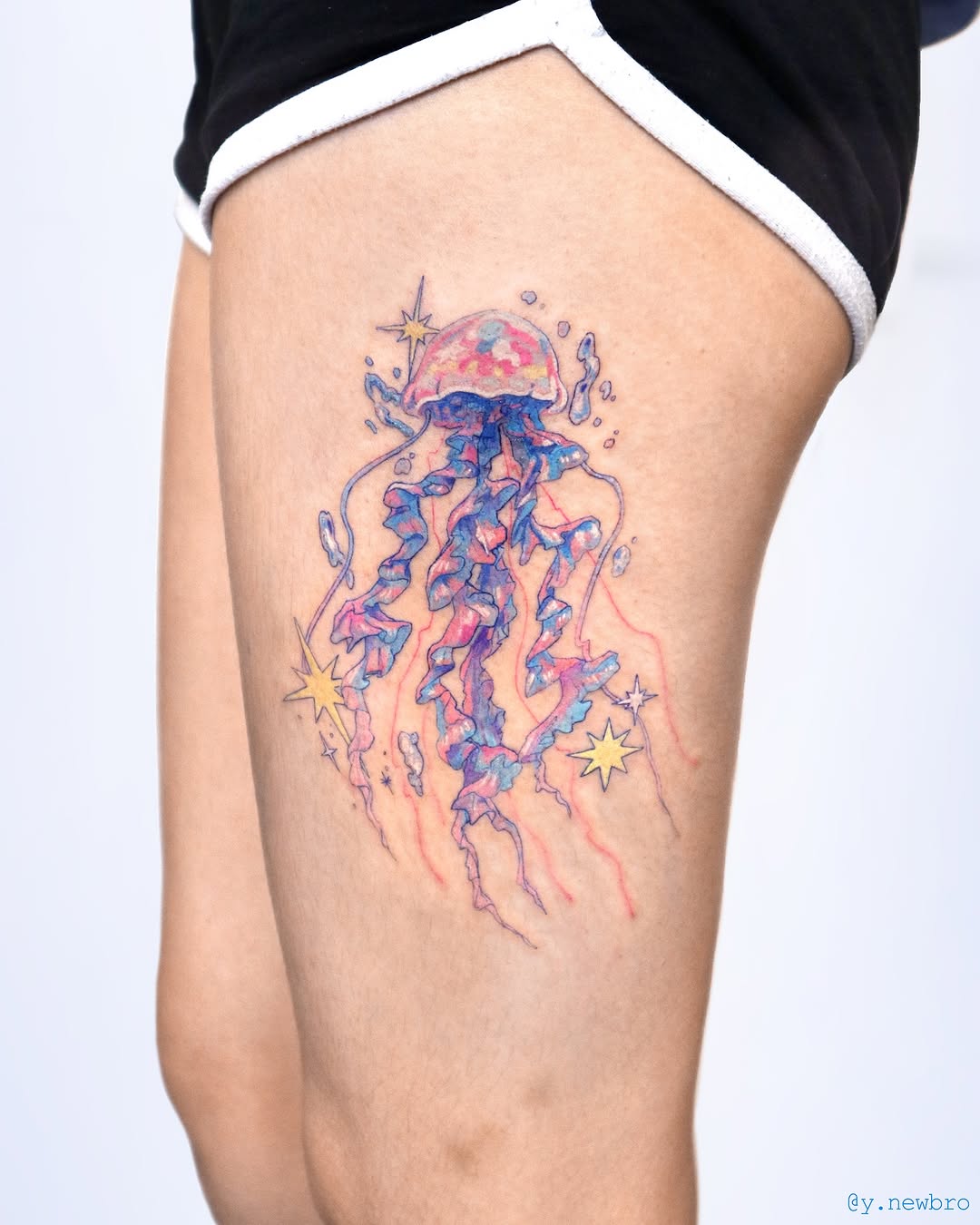 Colorful jellyfish tattoo radiating whimsical vibes Tattoo on skin