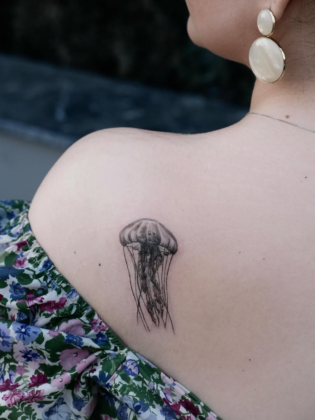 Elegant jellyfish tattoo on shoulder decor. Tattoo on skin