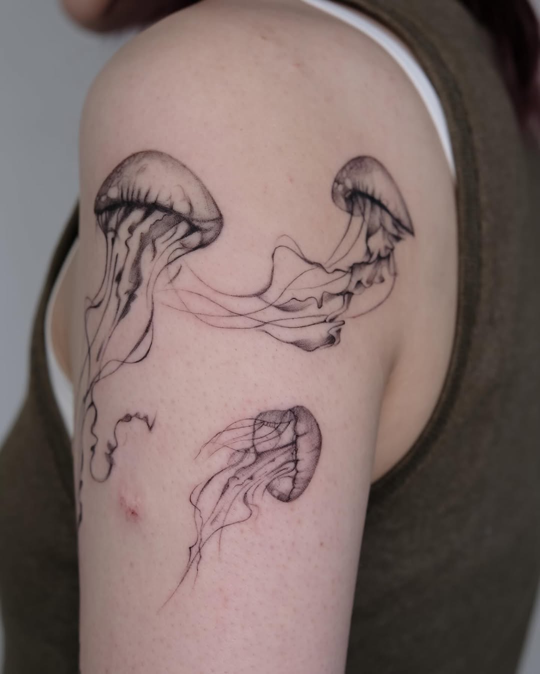 Elegant Jellyfish Tattoo on Upper Arm Tattoo on skin