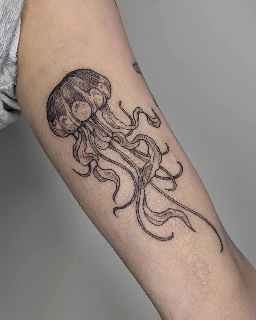 Elegant jellyfish tattoo with delicate linework Tattoo on skin
