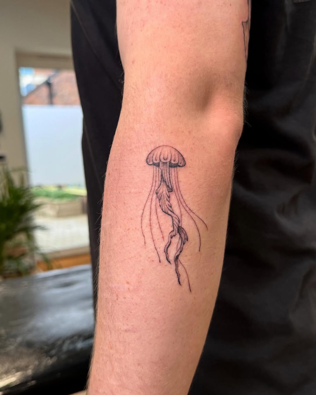 Elegant jellyfish tattoo with flowing tentacles Tattoo on skin
