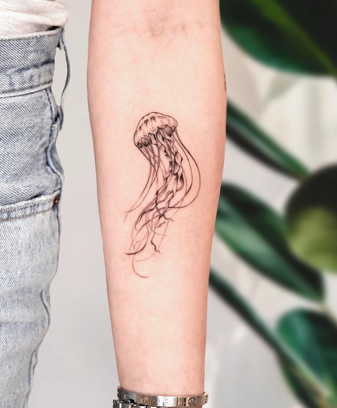 Minimalist jellyfish tattoo on the forearm Tattoo on skin