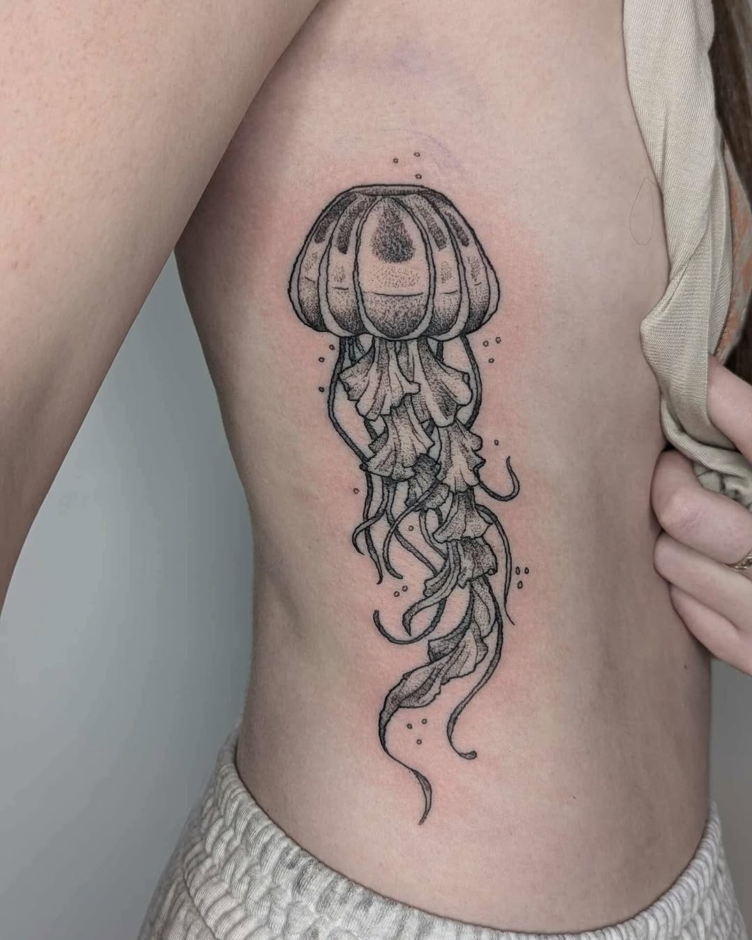 Stunning jellyfish tattoo on rib cage Tattoo on skin